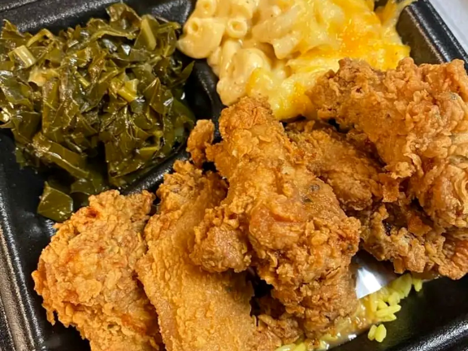 Mama Tia's Kitchen dinner of golden fried chicken with macaroni and cheese, collard greens and seasoned rice